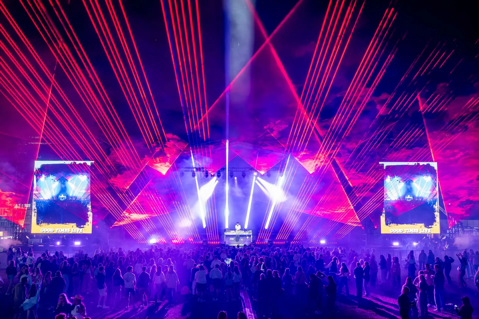 Laser show at the Good Times Festival: red and blue laser beams above the stage and the audience