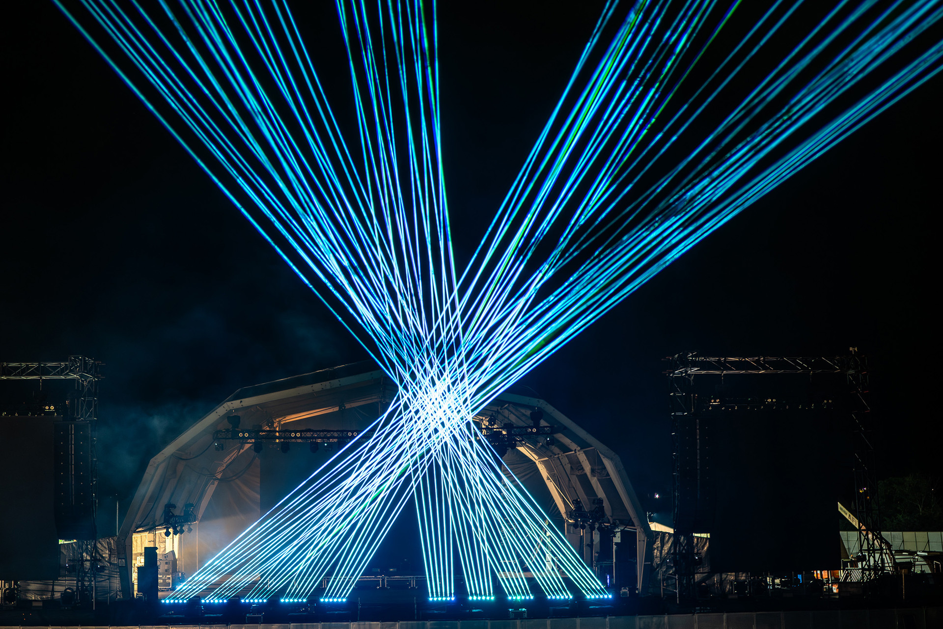 Blue laser fans above a stage